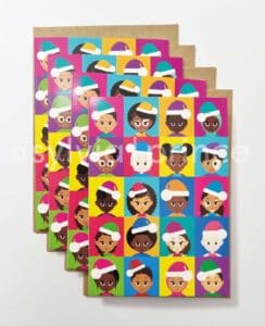 Cartoon style illustration of 20 happy, young children in various shades of black and brown, two living with albinism, six living with vitiligo. They all have different hairstyles and two of the girls are wearing hijabs. They are all wearing brightly coloured 'Santa' hats with white bobbles and trims, and tops in a variety of bright colours. The background is a patchwork of different colours.