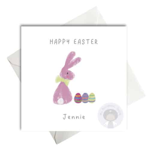 cute pink bunny with a row of three easter eggs