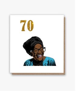 Joyful black lady with a black headscarf and blue top, wearing glasses, smiling broadly on a 70th birthday card.