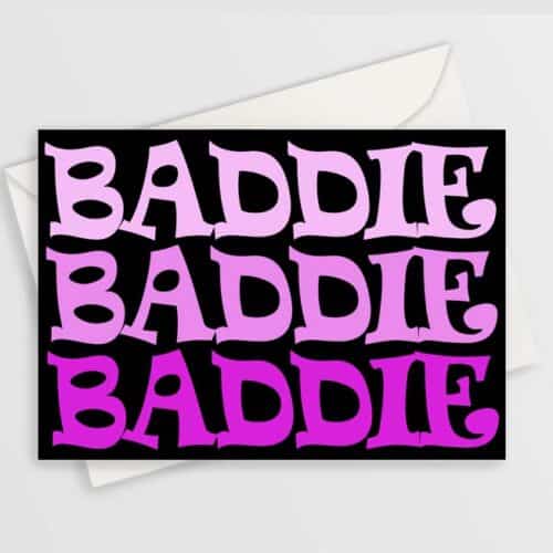 Greeting card with bold pink "baddie" text repeated 3 times on black background, shown with a plain envelope